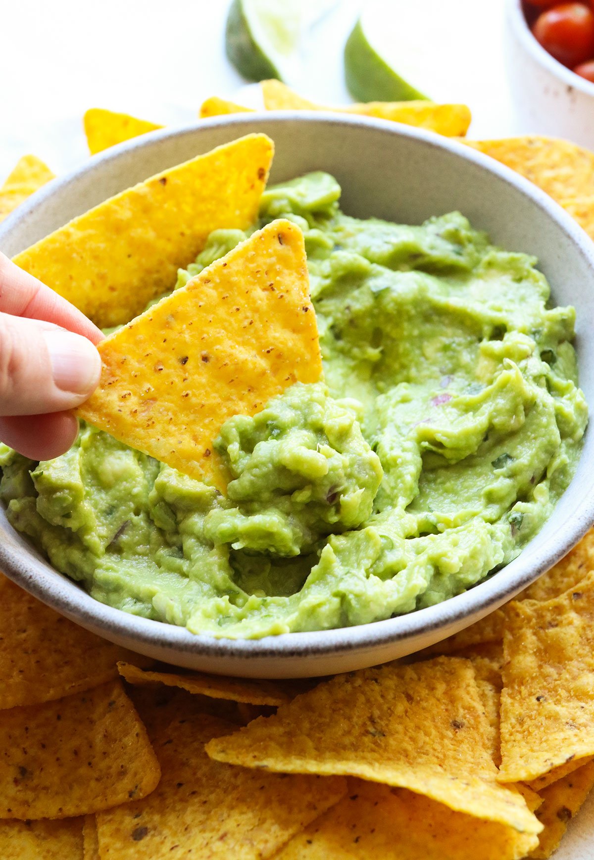 tortilla chip dipped into a bowl of guacamole.