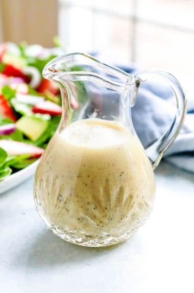 lemon poppy seed dressing in glass pitcher
