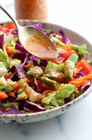 peanut dressing poured over salad