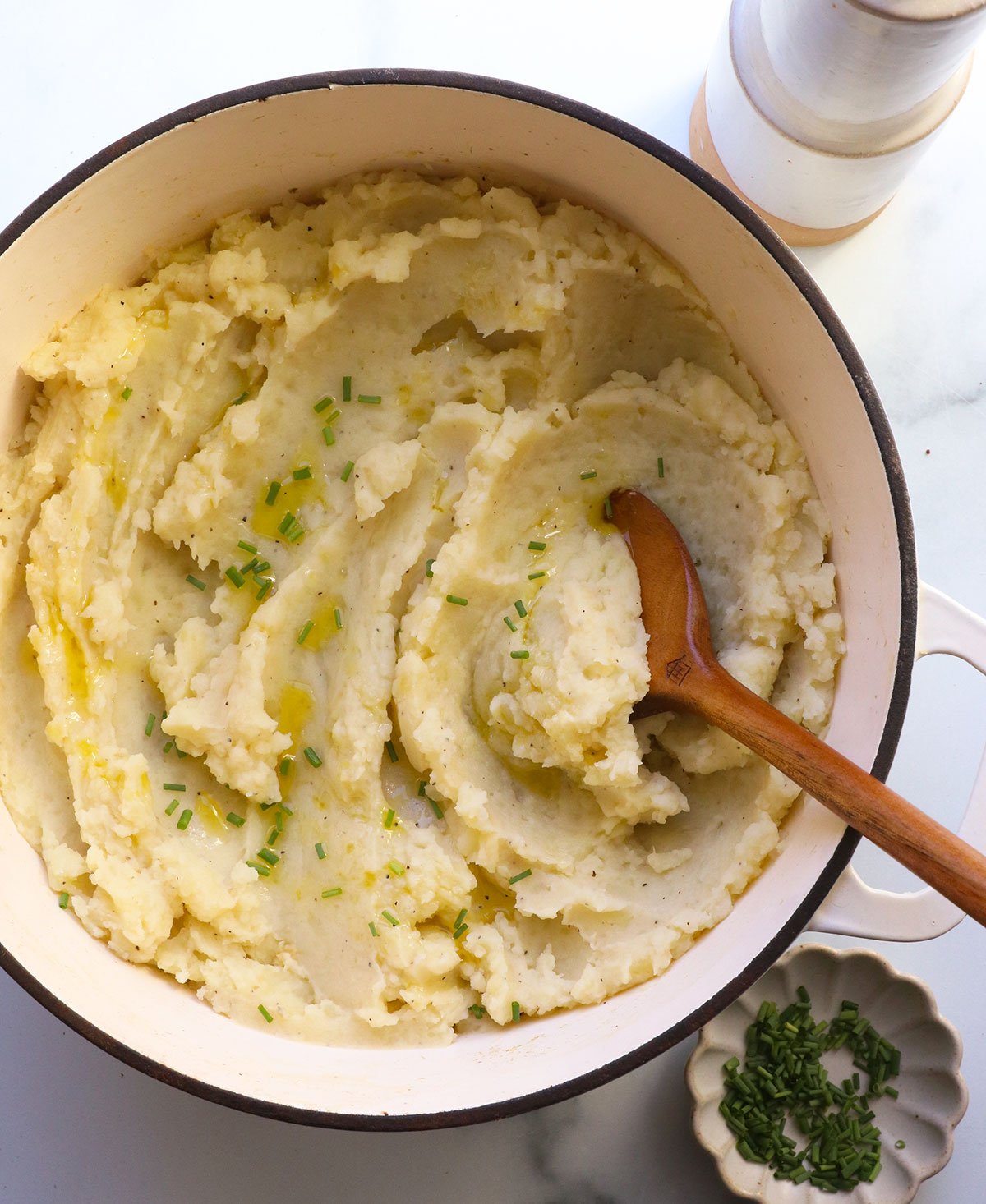 vegan mashed potatoes topped with olive oil and chopped chives.